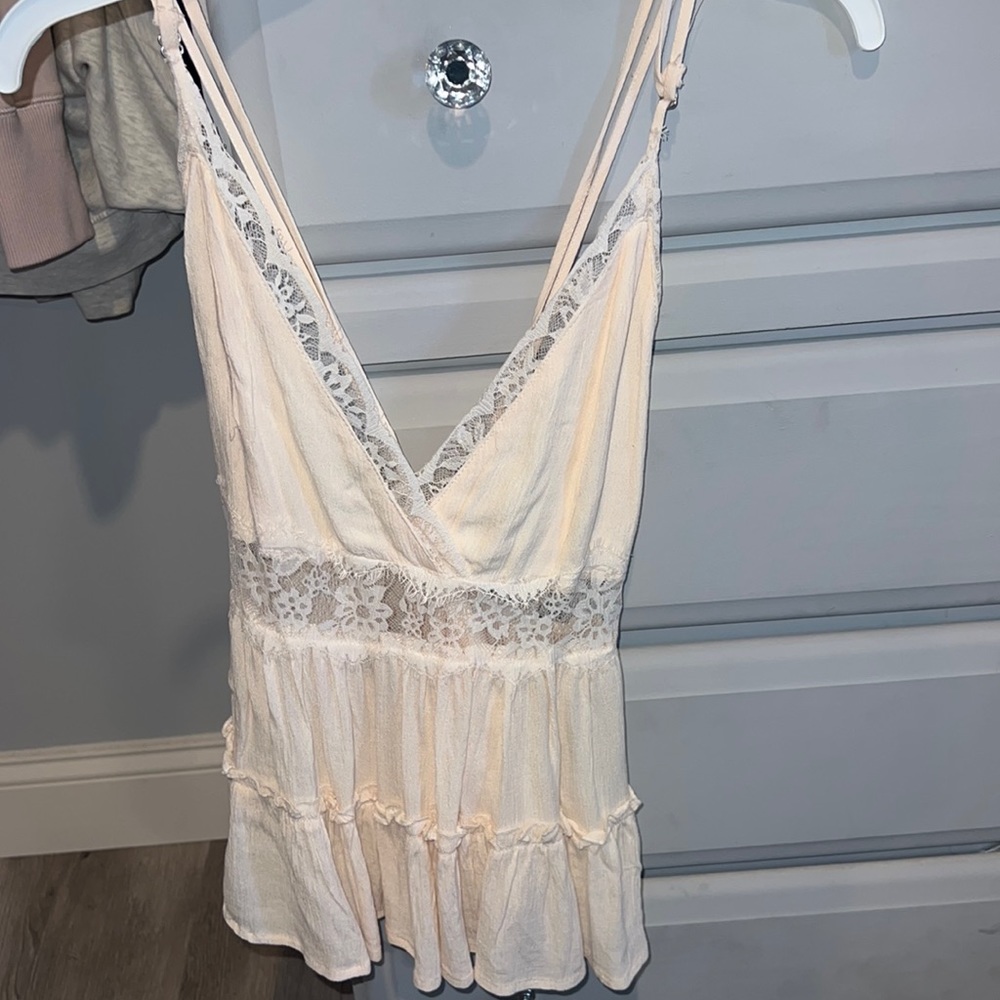 Light pink Tank top with lace detail and crossed strap back